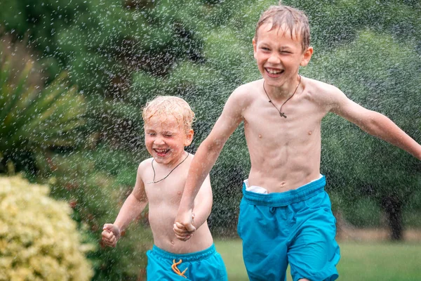 Kids Play Water Hot Summer Day Children Garden Sprinkler Having — стоковое фото
