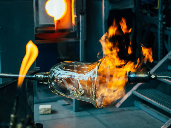 Creating traditional glass Art with Hot Torch and glassblowing pipe. Creating the heavy glass bowl by traditional method