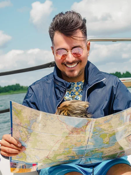 Smiling Candid Black Hair Young Man Look Map Sitting Sailboat — Fotografia de Stock