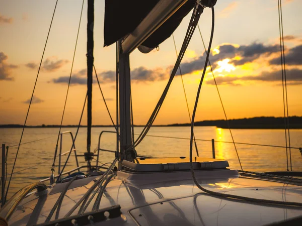 sailing yacht bow in sunset light, sailing on a lake