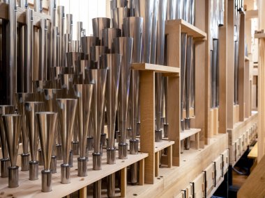 Inside a contemporary organ in modern philharmonic hall, register with different steel pipes. structure of organ