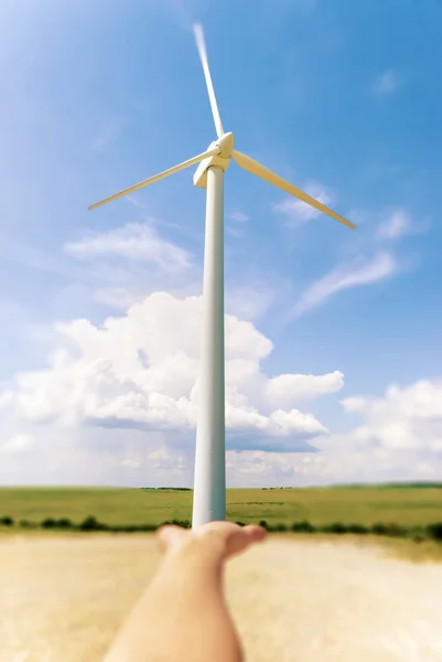 Stock Photo of hand holding a windmill. Background a blue sky — Stock Photo, Image