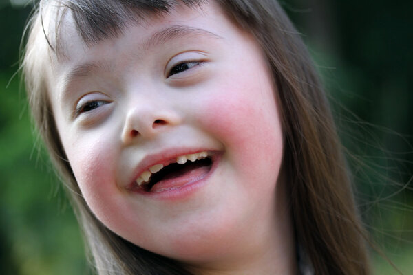 Portrait of beautiful young girl on the green background.