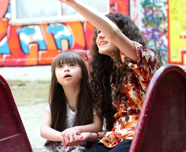 Beautiful young girls on the playground. — Stock Photo, Image