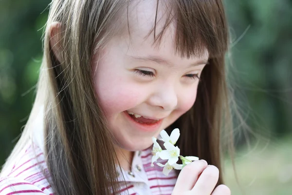 Retrato de menina bonita com flores no parque — Fotografia de Stock