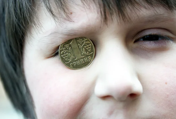 Funny boy with the ukrainian coin on the eye — Stock Photo, Image
