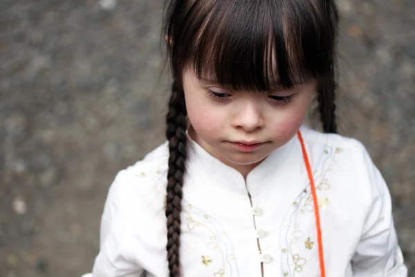 Little girl on grey background — Stock Photo, Image