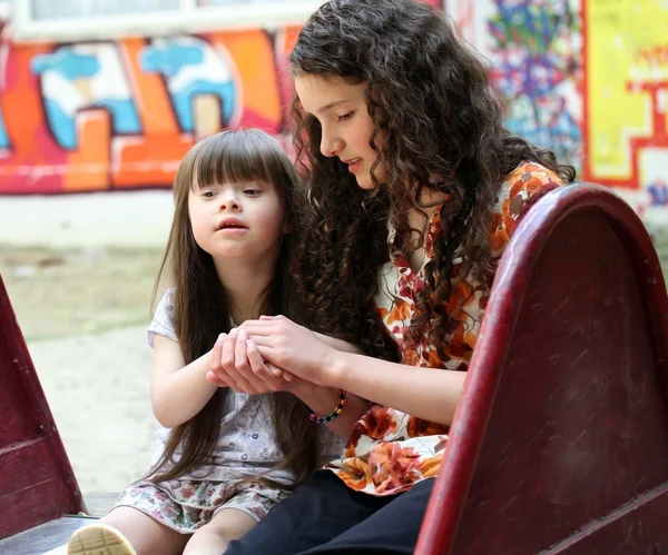 Portrait of beautiful young girls on the playground. — Stock Photo, Image