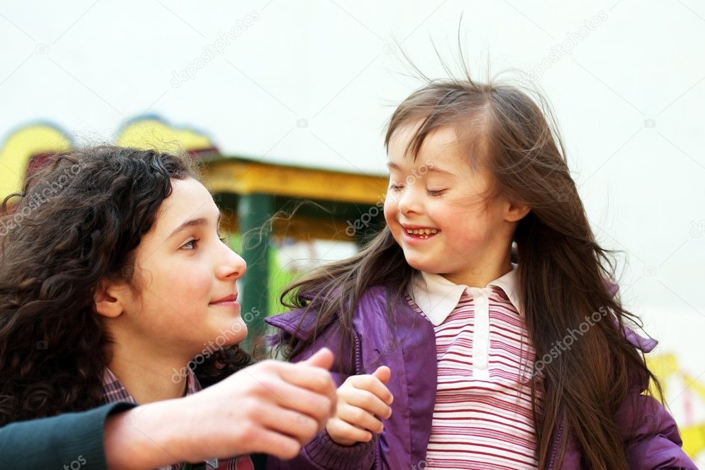 Portrait of beautiful young girls on the playground
