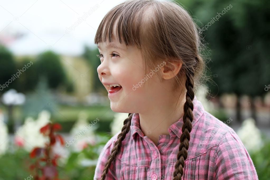 Portrait of beautiful young girl in the park .