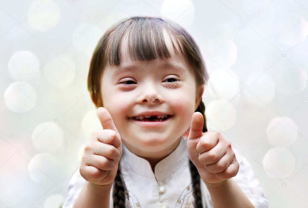 Portrait of beautiful happy girl giving thumbs up.