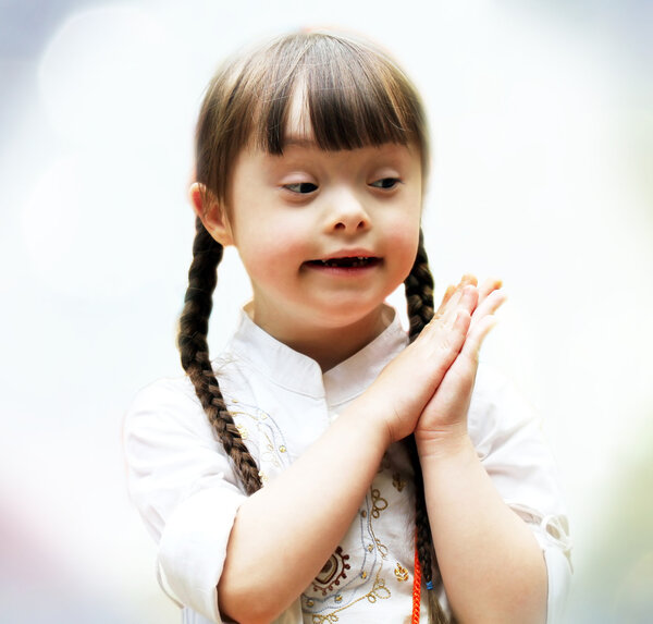 Portrait of beautiful young girl praying