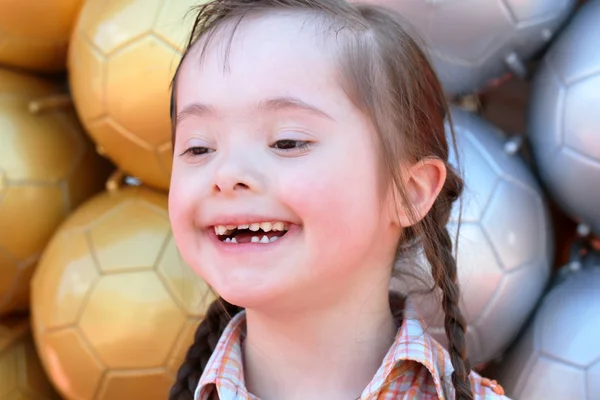 Little girl on the background of soccer balls. — Stock Photo, Image