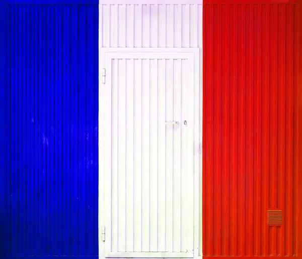 French flag on the background of old locked doors. — Stock Photo, Image