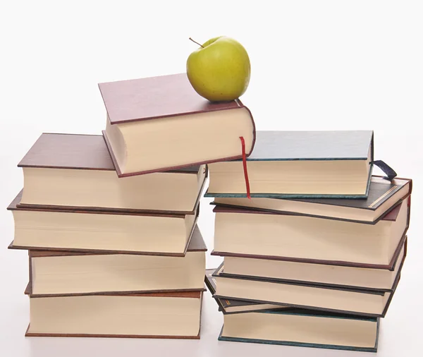 Stack of books with green apple — Stock Photo, Image