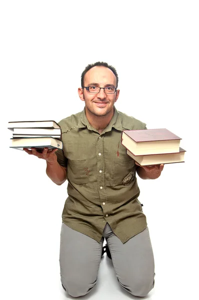 Young man kneeling punished with books in hands — Stock Photo, Image