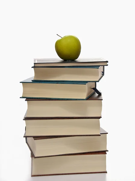 Stack of books with green apple — Stock Photo, Image