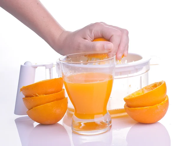 Hand squeezing orange for juice — Stock Photo, Image