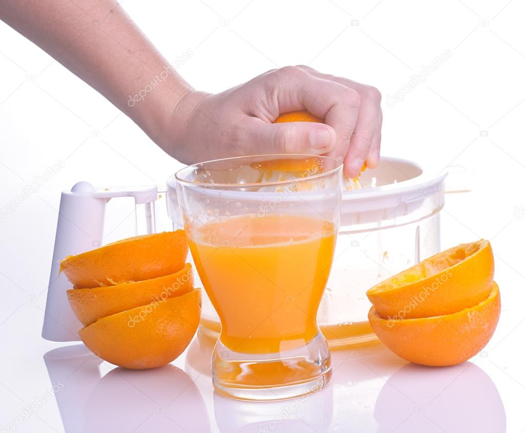Hand squeezing orange for juice