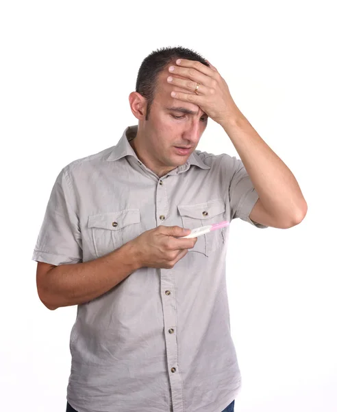 Sad man with pregnancy test Stock Picture