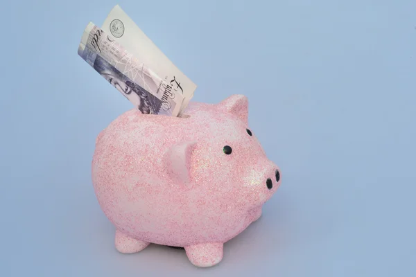 Piggy Bank med tyve pund note - Stock-foto