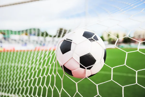 Football in the goal net — Stock Photo, Image
