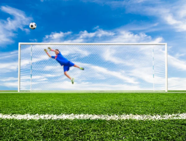 Foot shooting soccer ball out of goal — Stock Photo, Image
