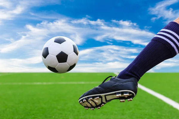 Foot kicking soccer ball — Stock Photo, Image