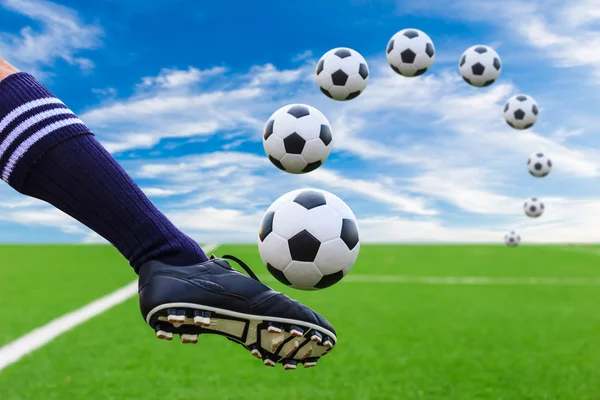 Foot kicking soccer ball — Stock Photo, Image