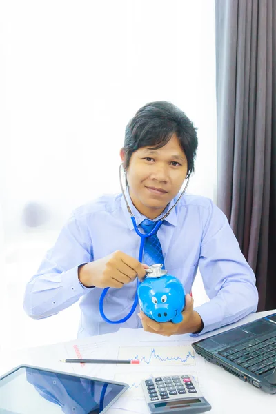 Business man with stethoscope checking piggy bank , financial di — Stock Photo, Image