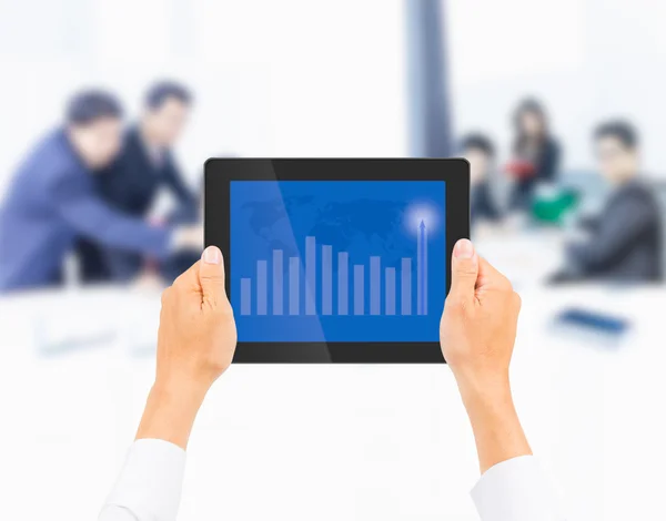 Hand holding tablet PC with higher financial graph on business — Stock Photo, Image