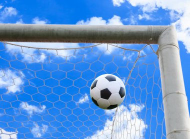 Futbol topu gol ağında.