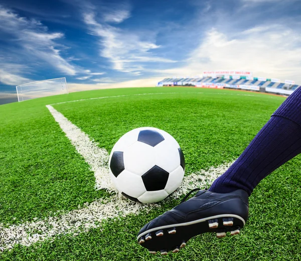 Foot kicking soccer ball — Stock Photo, Image