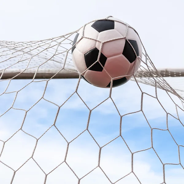 Soccer ball in goal net — Stock Photo, Image