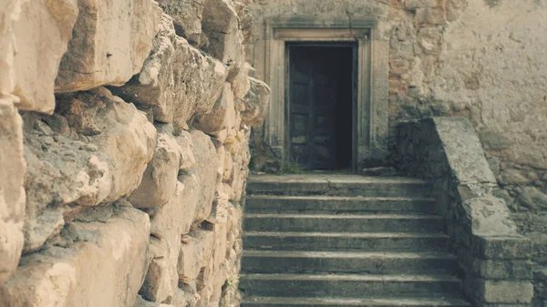 Medieval walls and a door in a castle. Focus on the wall