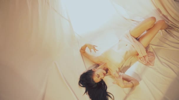 Sensual Girl Relaxes Light Fabrics — стоковое видео