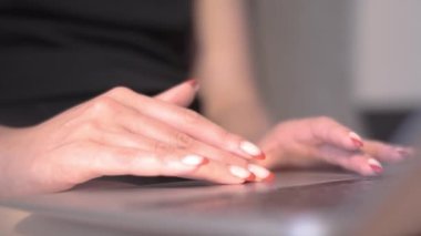 Woman touching laptop touchpad. Close up