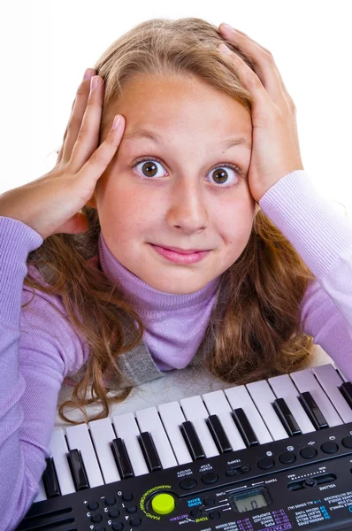 Schoolgirl playing on a small synthesizer — Stock Photo, Image