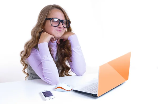 Schoolgirl with netbok and mobile phone Royalty Free Stock Images