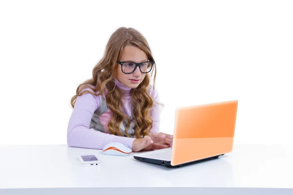 Schoolgirl with netbok and mobile phone Stock Picture