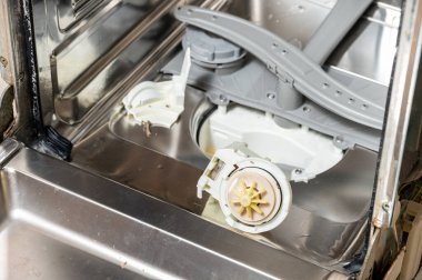 Parçalanmış bulaşık makinesinde eski bir bulaşık makinesi pompası