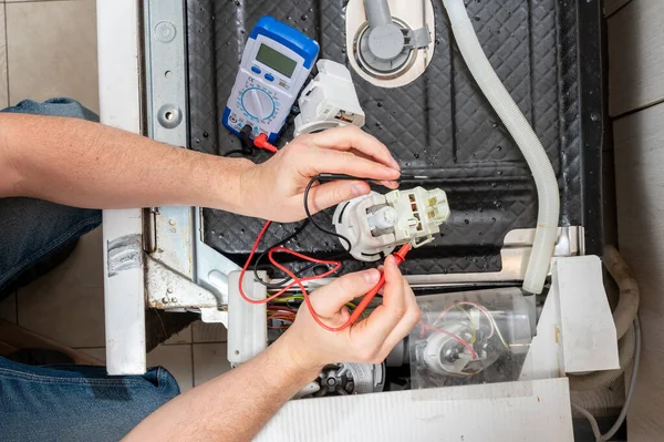 Man Takes Measurements Electric Tester Dishwasher Parts — Stock Photo, Image