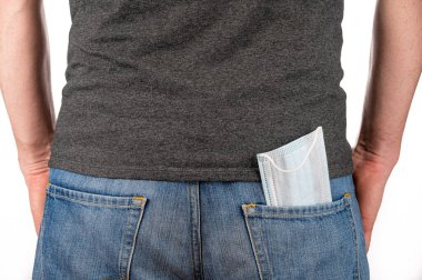 Kot pantolonun arka cebinde tıbbi maske