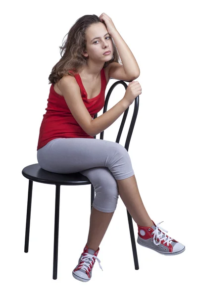 Девушка, сидящая на стуле — стоковое фото