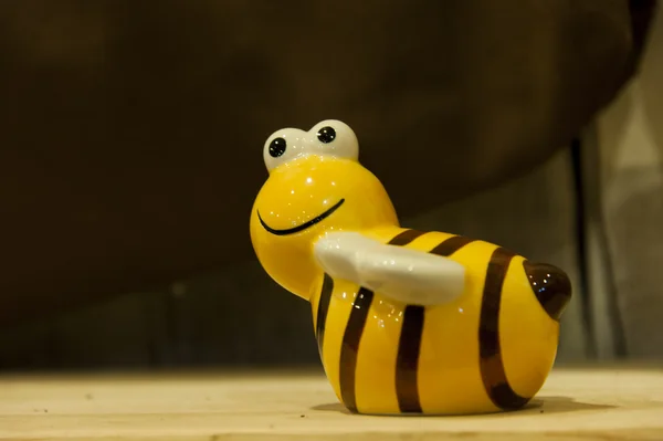 One little yellow ceramic Bee on the shelf — Stock Photo, Image