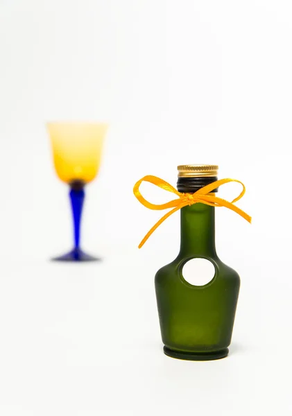 Zoom in green whisky bottle with blur glass isolated on white background — Stock Photo, Image