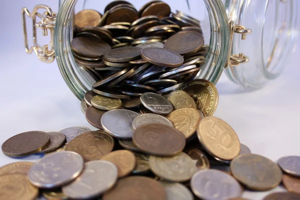 Coins spill out of the jar — Stock Photo, Image