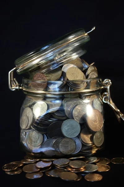 Monedas en un frasco de vidrio — Foto de Stock