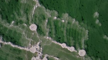 Overhead drone flight of abstract patterns of salt deposits and turquoise blue water of the Dead Sea. Famous landmark and natural phenomenon in Israel and Jordan. 