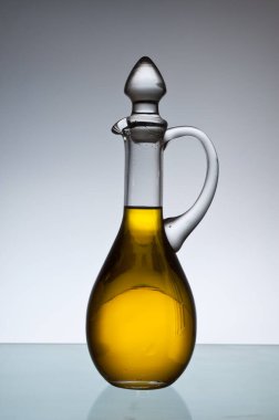 Olive oil bottle in backlight.